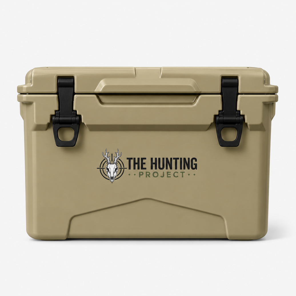 A tan hard-sided cooler with black latches and a printed logo reading 'THE HUNTING PROJECT' on the front, photographed against a clean white background.